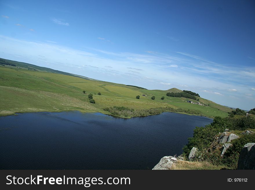 Wonderful sunny day on the cragg of Northumberland, with a small hill farm and blue lough depitcitng a scene of Northumberland