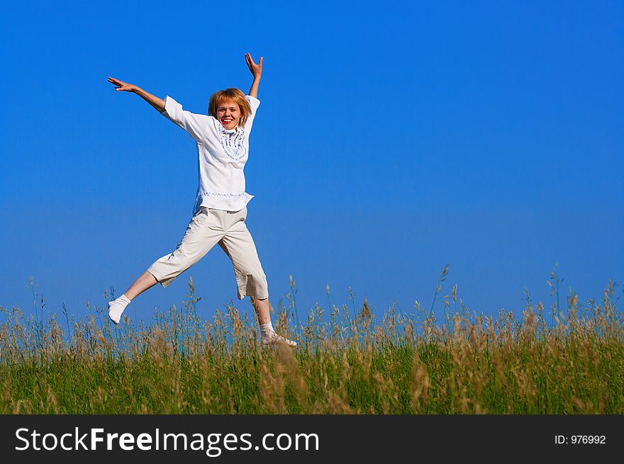 beauty girl jumping in field