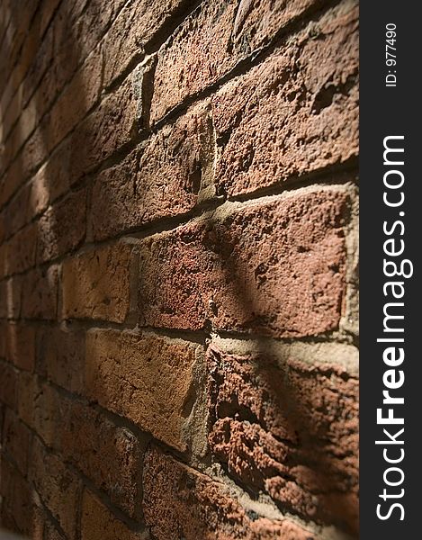 Textured brick wall with shadows and highlights