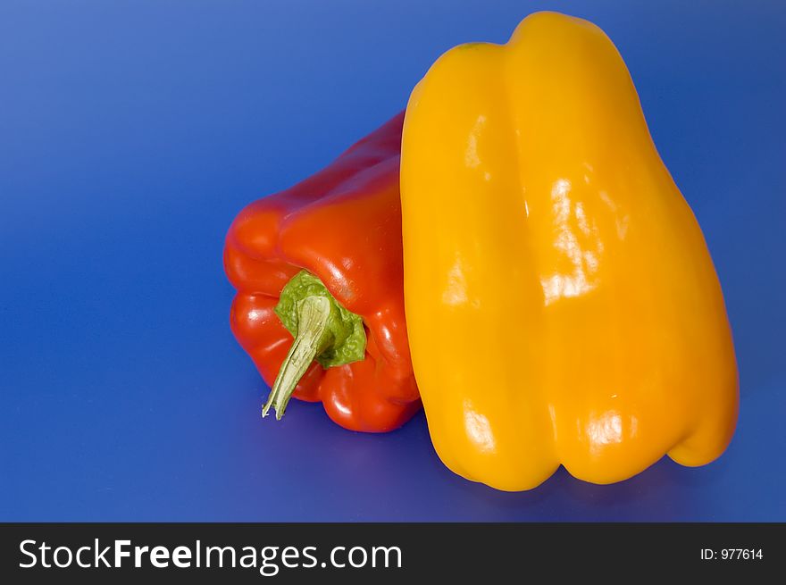 Red and yellow peppers on a blue background