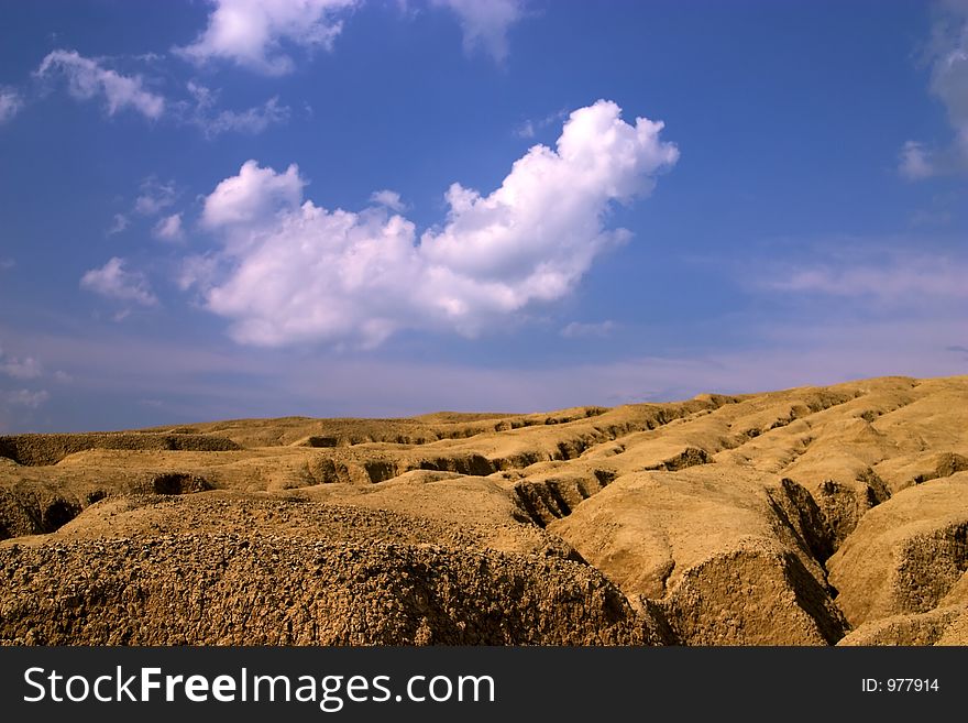 Mud canion wuth spectacular sky from Mud Volcanoes - Buzau, Romania (unique geological phenomenon in Europe where the earth gas reaches the surface through hills making small Mud volcanoes)