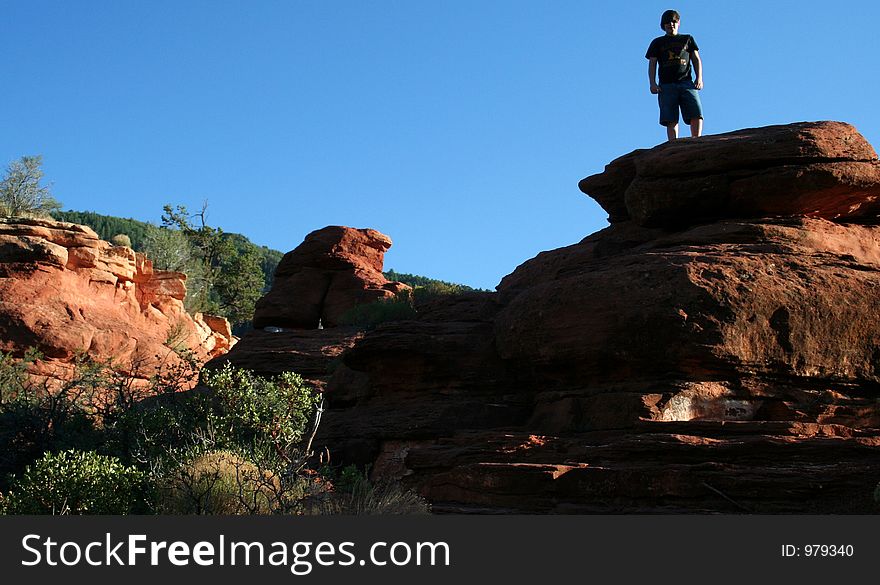 Young boy standing on top of rocks. Young boy standing on top of rocks