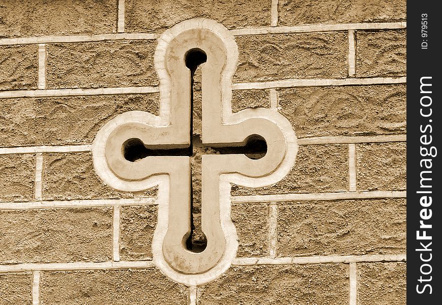 Antique cross window on historic building. Antique cross window on historic building