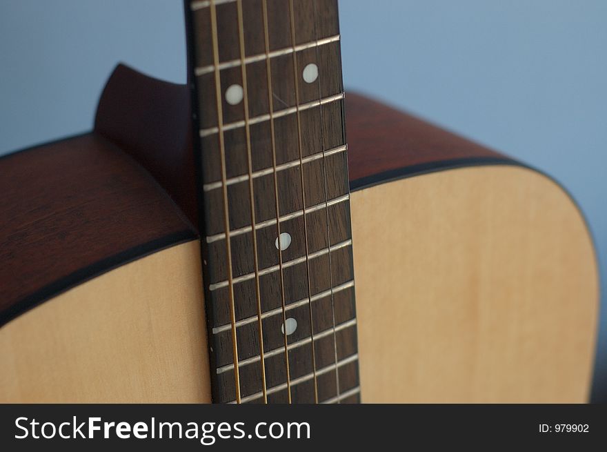 Acoustic guitar on a blue background