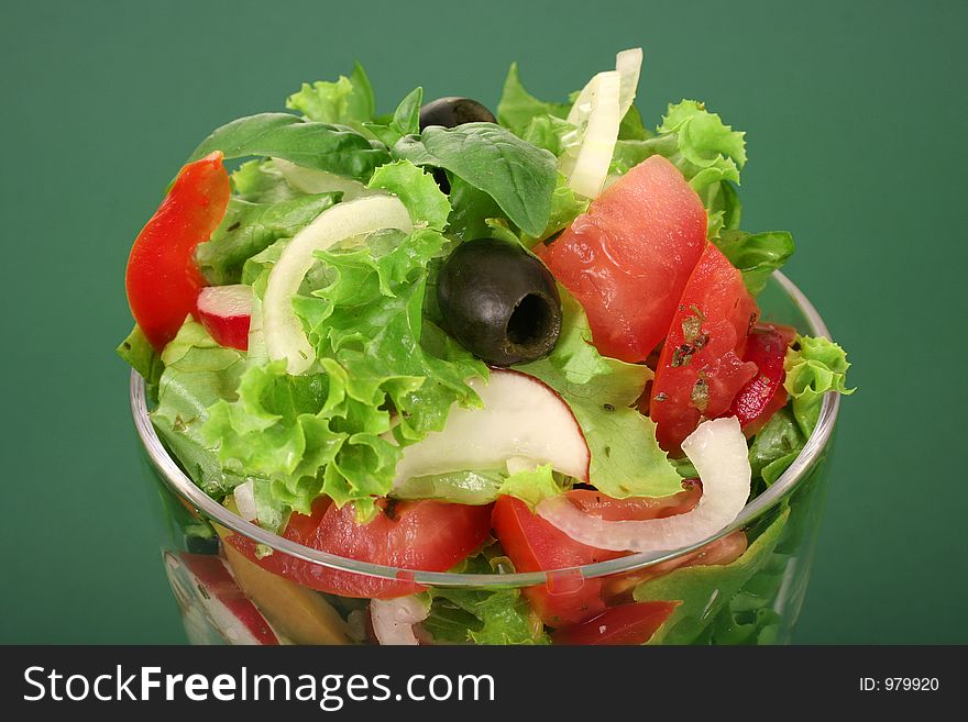 A fresh olive salad on green background