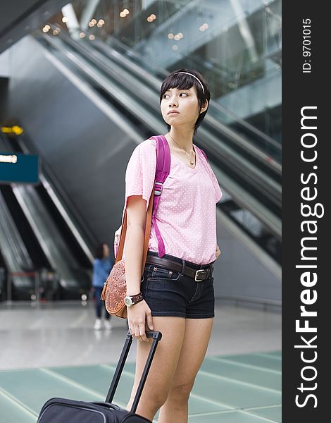 An asian girl at singapore's changi airport terminal