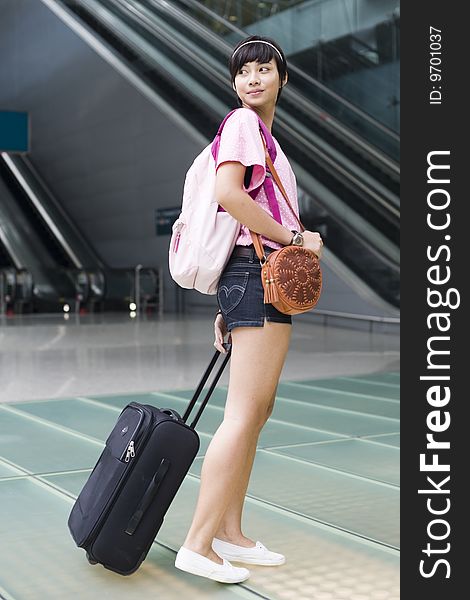 An asian girl at singapore's changi airport terminal