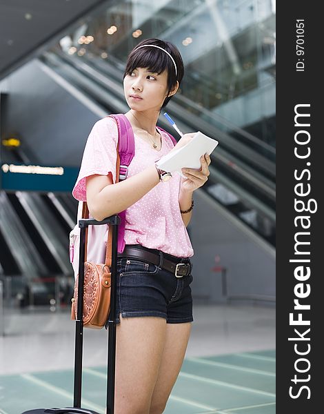 An asian girl at singapore's changi airport terminal