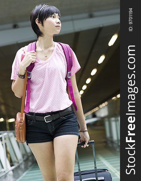 An asian girl at singapore's changi airport terminal