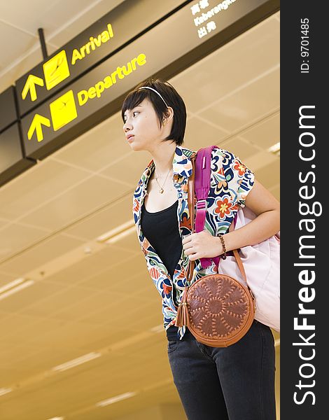 An asian girl at singapore's changi airport terminal