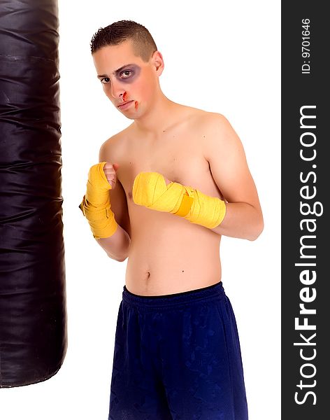 Youngster practicing the art of boxing with a punch-bag, studio shot on white background