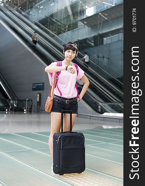 An asian girl at singapore's changi airport terminal