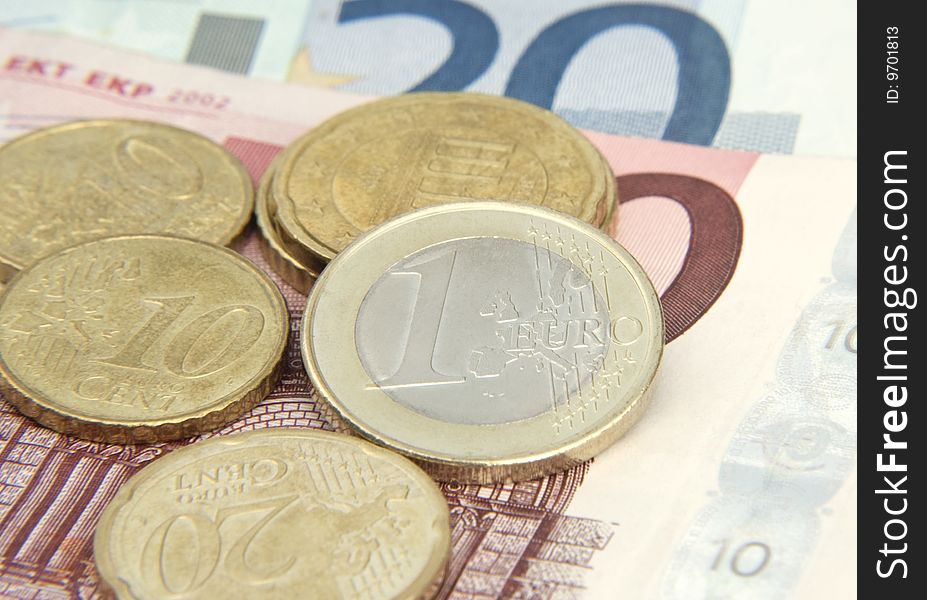 Close-up of Euro coins on bank notes. Close-up of Euro coins on bank notes