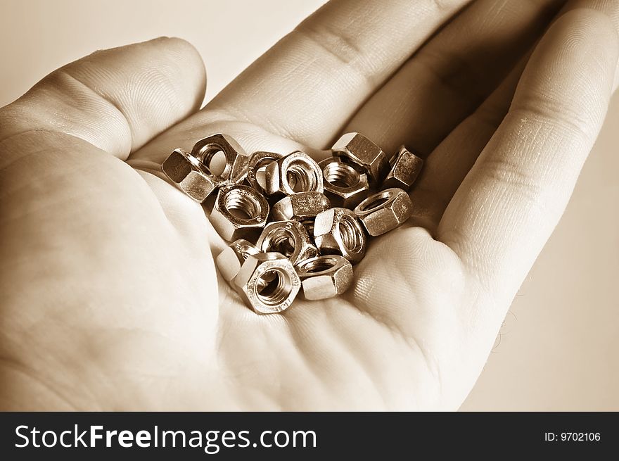 Close up hand with bolts and nuts