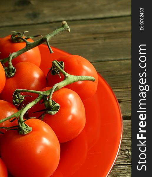 Tomatoes On A Red Plate On Wooden