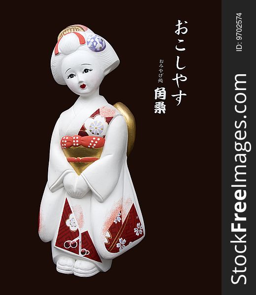Statue of a white geisha from Kyoto, Japan. This is an isolated subject on dark background. Statue of a white geisha from Kyoto, Japan. This is an isolated subject on dark background