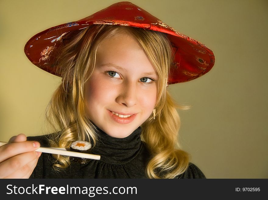 A smiling girl with chopsticks and sushi. A smiling girl with chopsticks and sushi