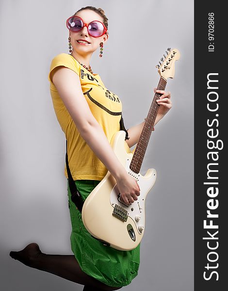 Smiling blonde with guitar isolated