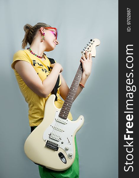 Young blonde with guitar isolated