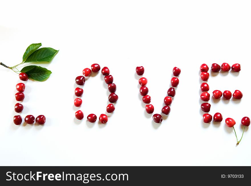 The the word love from sweet cherries which symbolize the love of two people