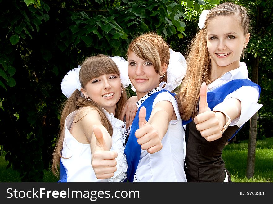 Three funny graduates posing outdoors