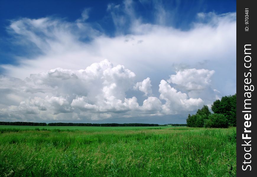 Clouds over the green grass.Siberia, the southern Altai. Clouds over the green grass.Siberia, the southern Altai