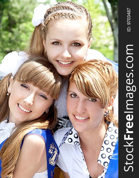 Three funny graduates posing outdoors