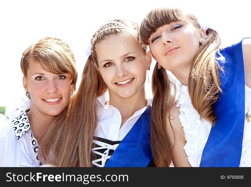 Three funny graduates posing outdoors