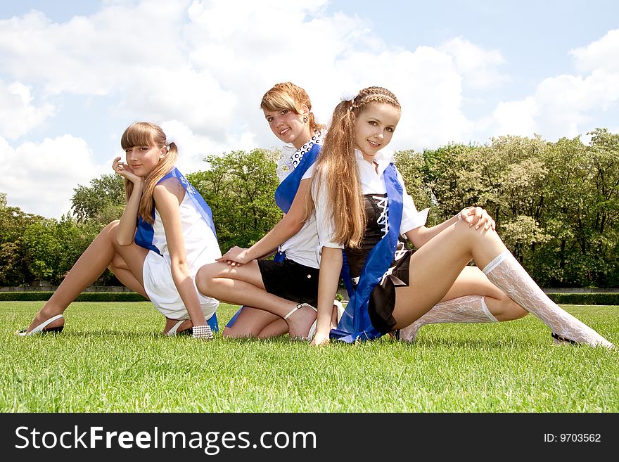 Three funny graduates posing outdoors