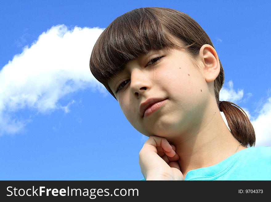 Close-up of nice young girl on background with blue sky and clouds. Isolated with clipping path. Close-up of nice young girl on background with blue sky and clouds. Isolated with clipping path
