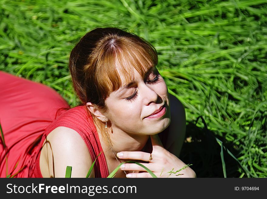Ggirl lying on the grass in the forest