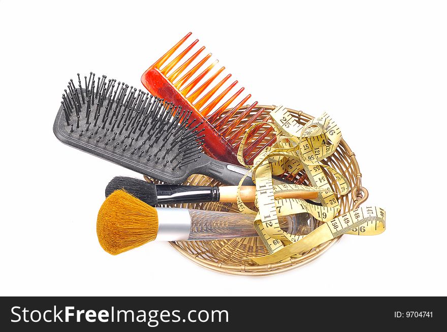 Brushes and comb in basket with measuring tape.