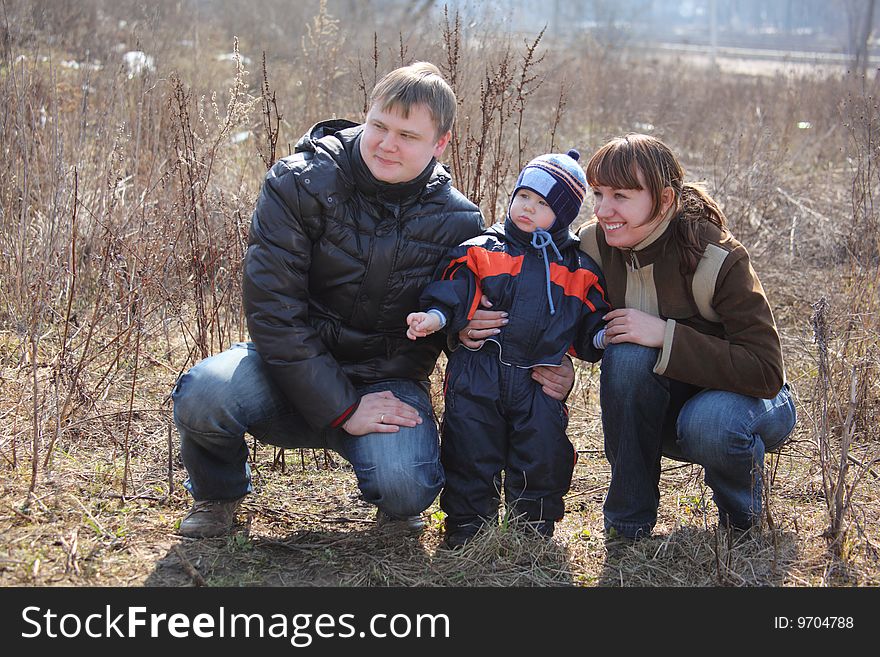 Parents With Child Outdoor In Spring