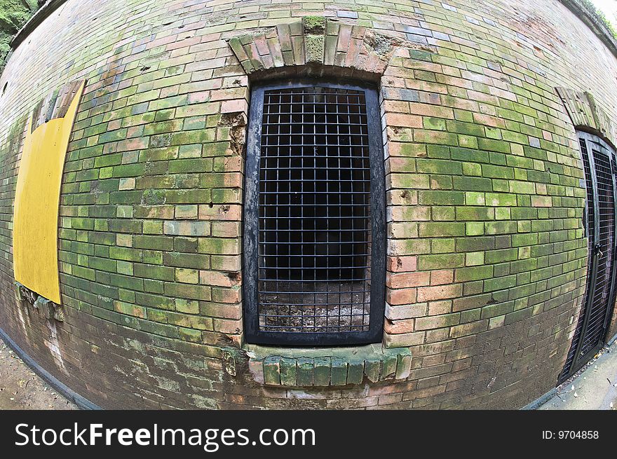 The iron grate blocking access to a weapons locker at an abandoned Japanese World War II era fort.