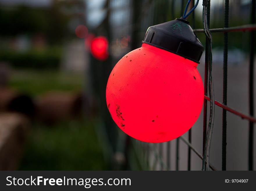Red lantern on a mesh fence