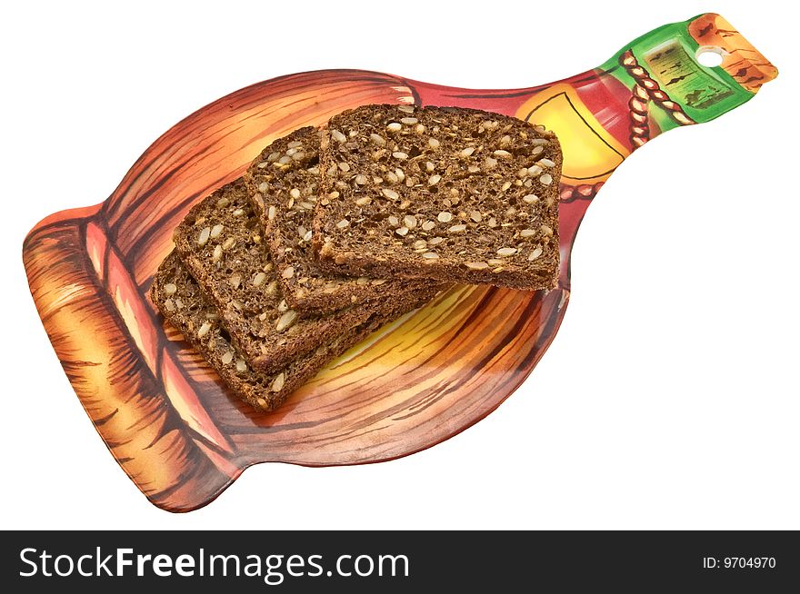 Black bread with sunflower seeds of a rough grinding cut by pieces on a chopping board. Black bread with sunflower seeds of a rough grinding cut by pieces on a chopping board