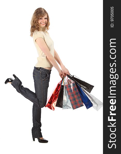 Happy blonde with paper bags full body on white