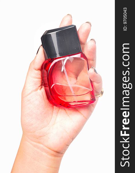 Red perfume bottle in female's hand.
