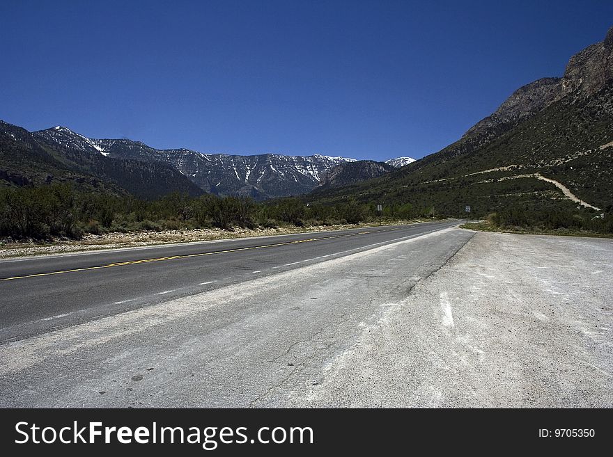 Empty freeway with the mountains on a horizon