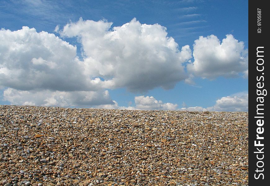 Shingle foreground with blue sky & clouds. Shingle foreground with blue sky & clouds