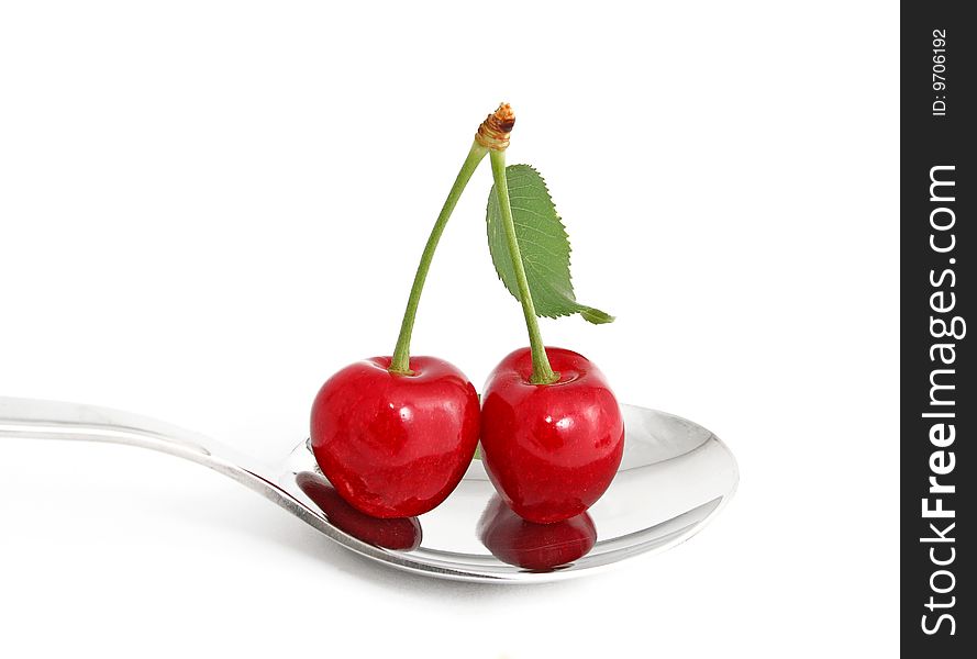 Ripe sweet cherries in spoon.It Is Insulated on white