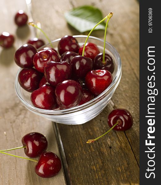 Cherry in a glass on a old wooden table