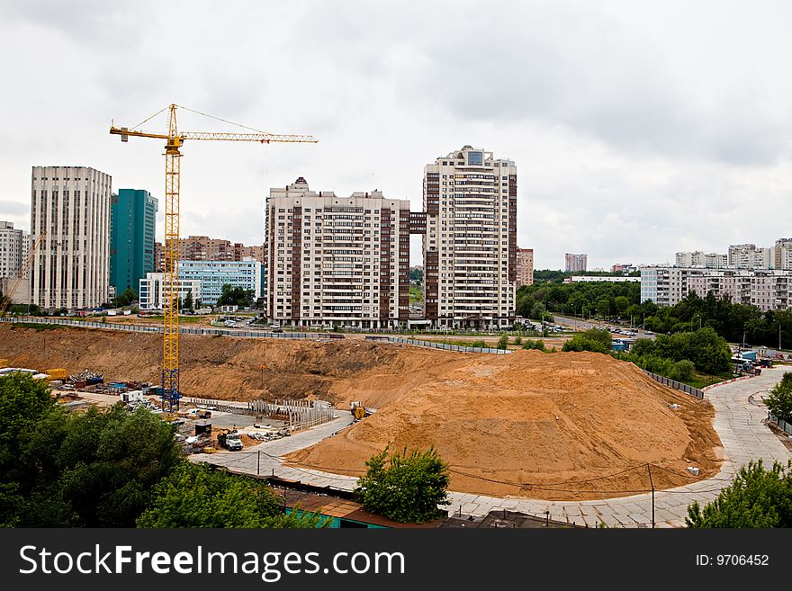 Building site with technics and the elevating crane