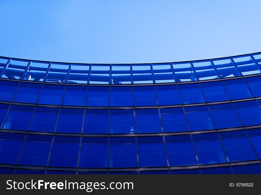 The blue background of the office building with windows. The blue background of the office building with windows