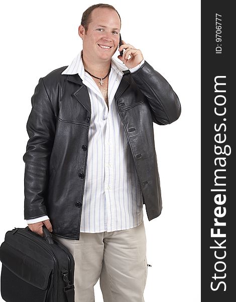 Young successful businessman wearing leather jacket talking on a cellphone and smiling. Isolated on white background. Young successful businessman wearing leather jacket talking on a cellphone and smiling. Isolated on white background