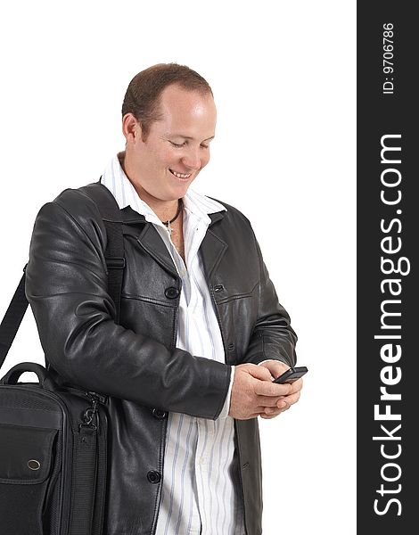 Young successful businessman wearing leather jacket smiling at a message on his cellphone. Isolated on white background. Young successful businessman wearing leather jacket smiling at a message on his cellphone. Isolated on white background