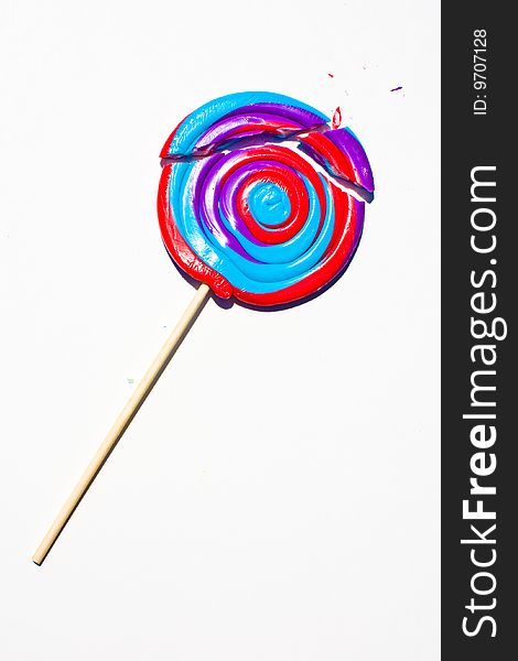 Giant brightly colored lollipop broken into three pieces. Giant brightly colored lollipop broken into three pieces.