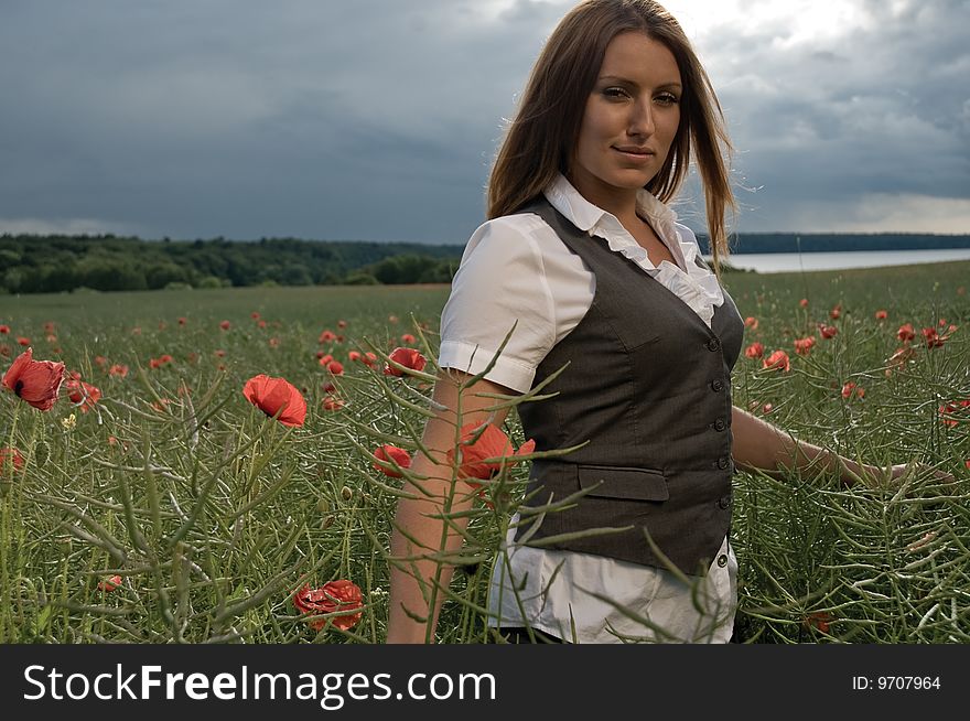 Young businesswoman in a field of flowers with powerful skies