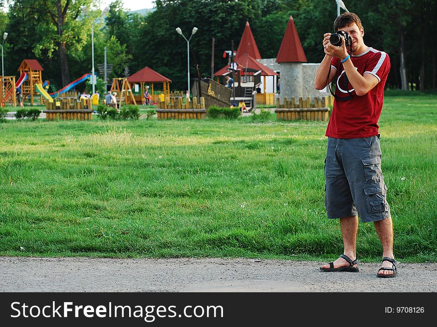 Young photographer shooting pictures outdoors. Young photographer shooting pictures outdoors