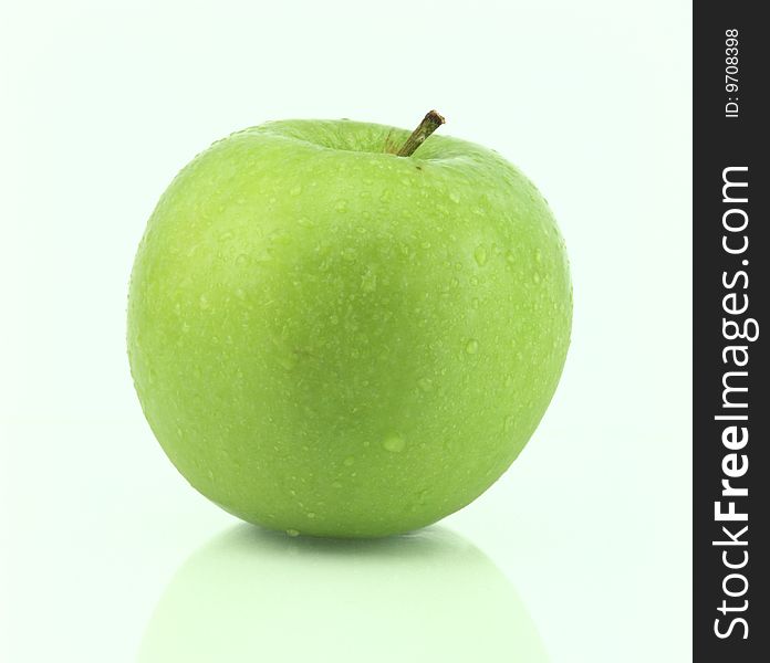 A fresh green apple with water drops